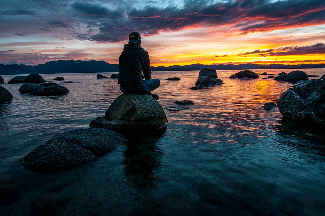 Zen man sitting on a rock 